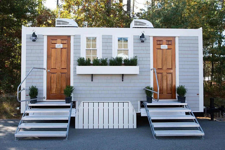 Luxury restroom trailer styled like a small house with his and hers doors